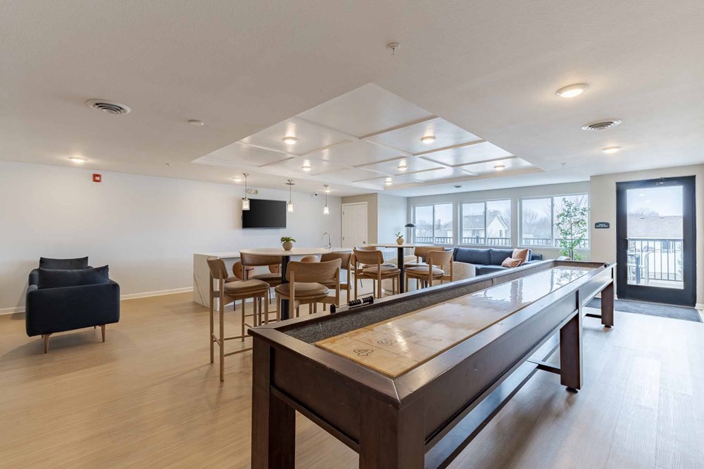 A modern living room with a long wooden table and chairs.