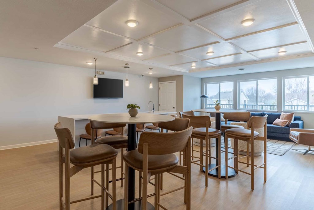 A modern living room with a bar area and a television.
