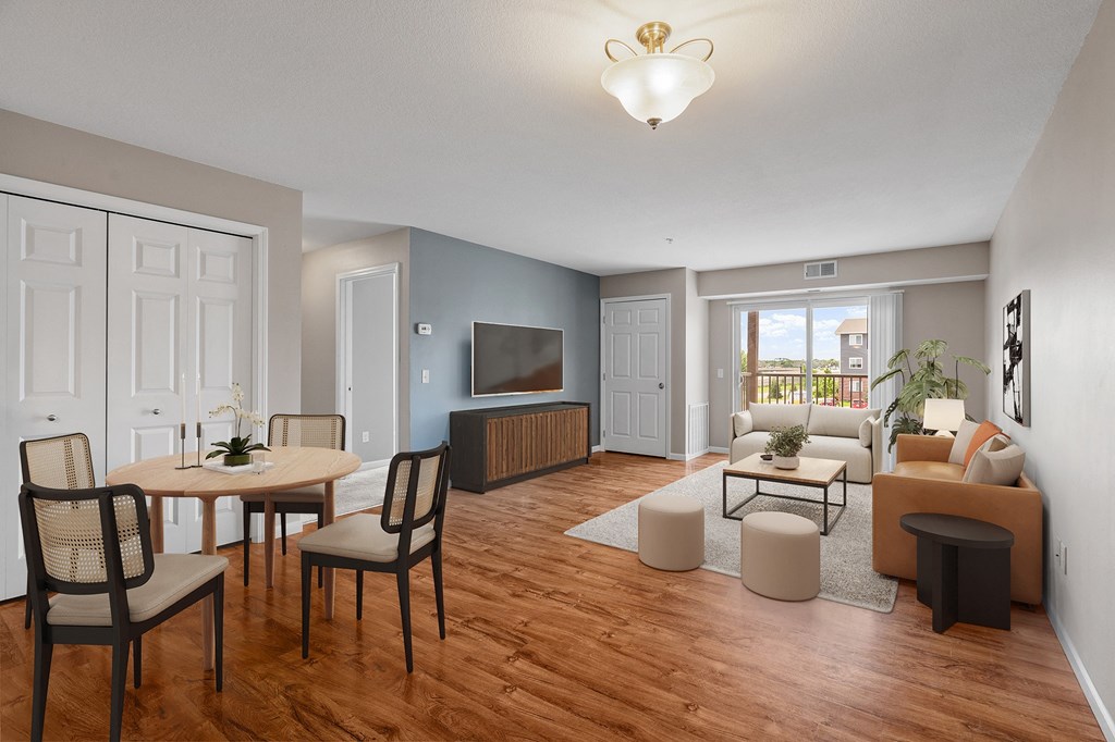 a living room and dining room with a couch and a tv