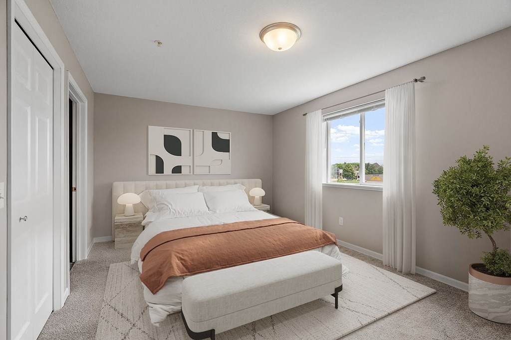 a bedroom with a bed and a window