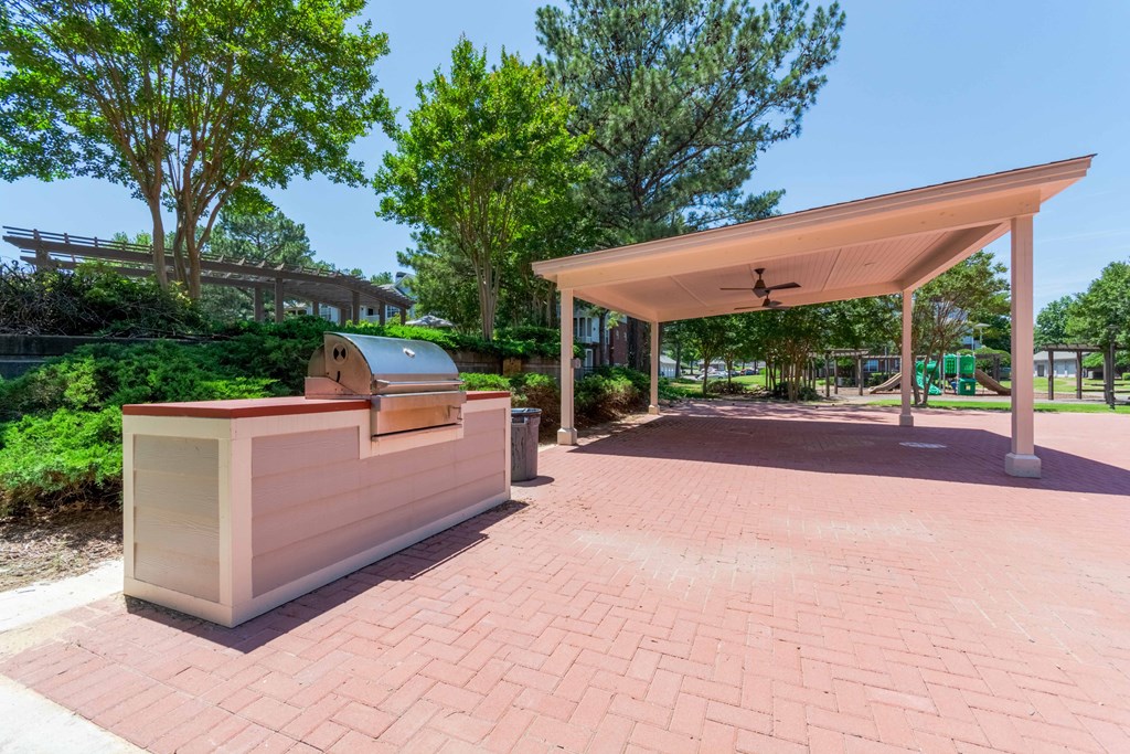 Picnic area with grilling station at Enclave at Wolfchase – Cordova, TN apartments with outdoor amenities.