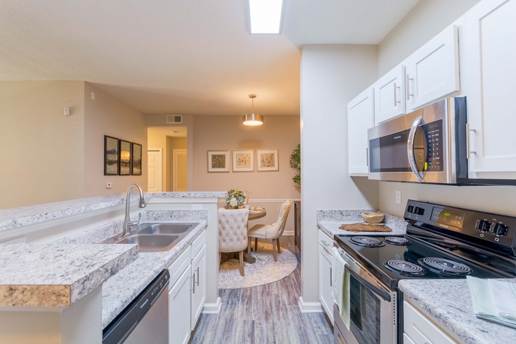 Open-concept kitchen and living room in Cordova, TN apartments at Enclave at Wolfchase – perfect for entertaining.