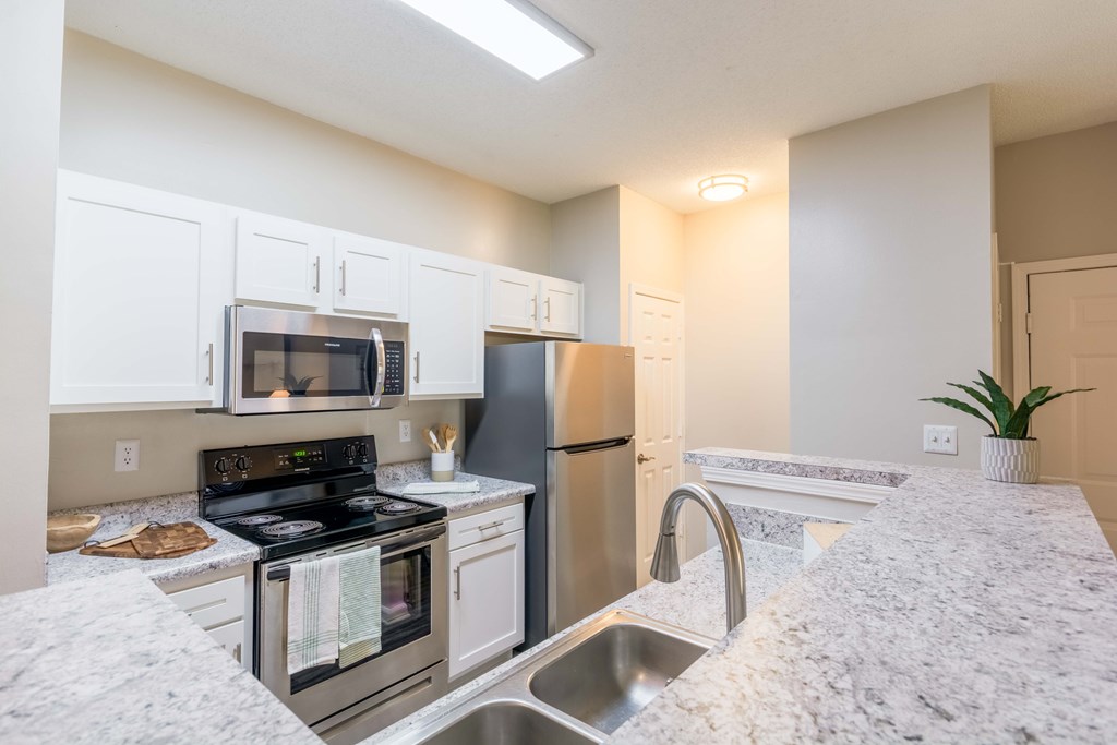 Fully equipped kitchen with stainless steel appliances at Enclave at Wolfchase Apartments in Cordova, TN.