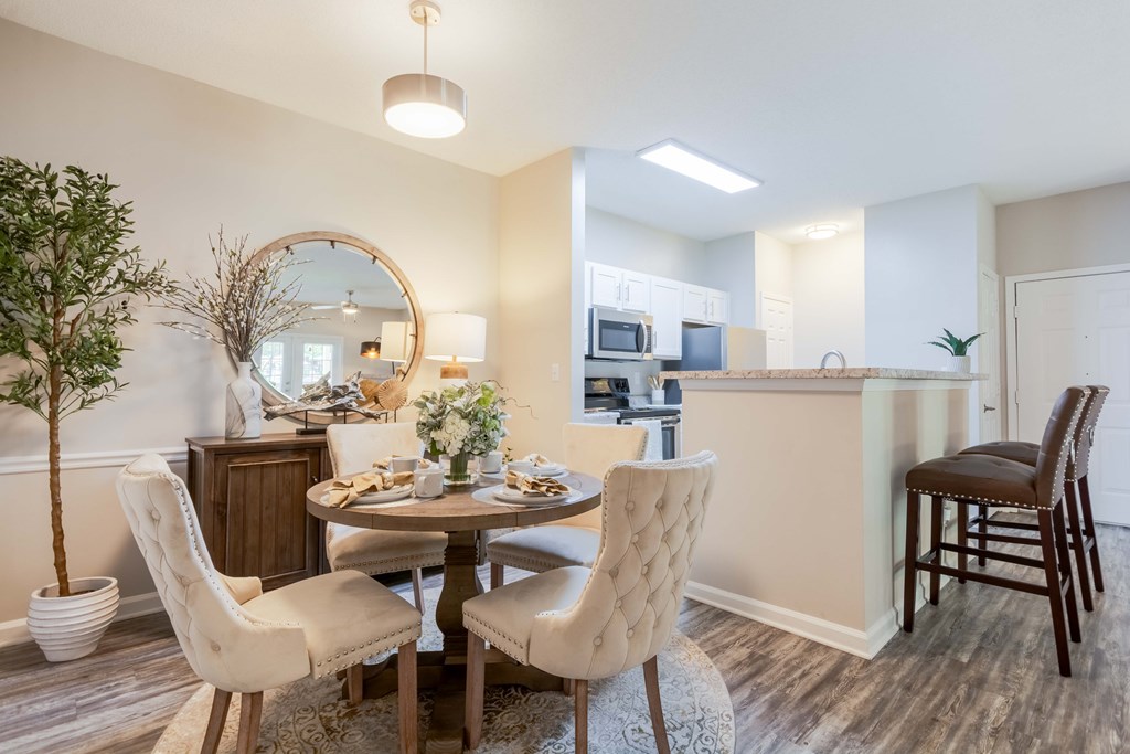 Contemporary dining area with hardwood-style flooring at Enclave at Wolfchase – apartments near Memphis, TN.