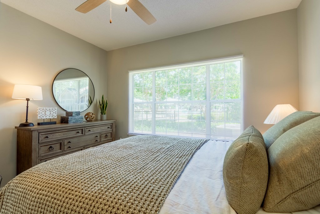 Comfortable bedroom with ceiling fan at Enclave at Wolfchase Apartments – pet-friendly homes in Cordova, TN.
