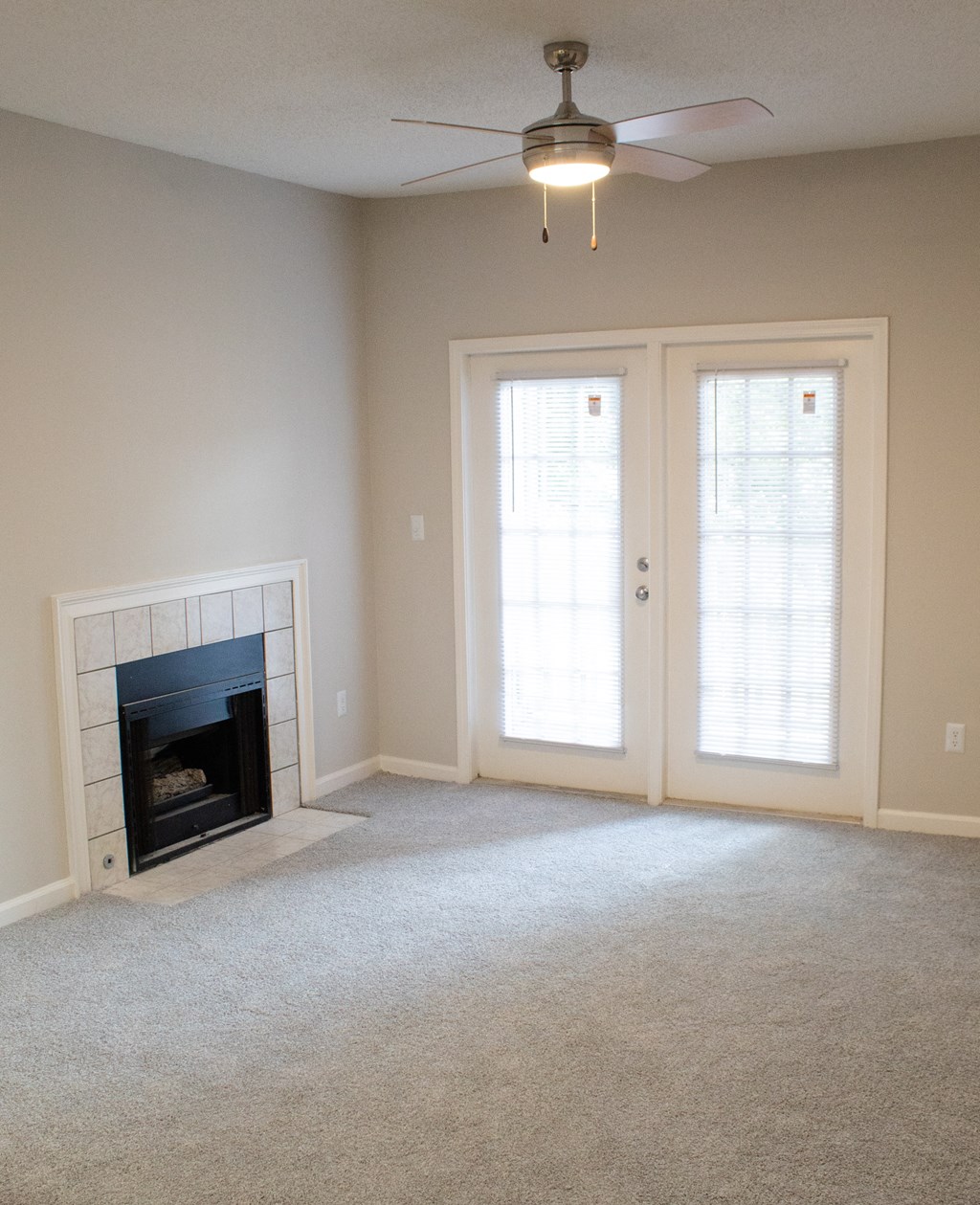 Enclave at Wolfchase Apartments in Cordova Tennessee photo of a living room with a fireplace and a ceiling fan