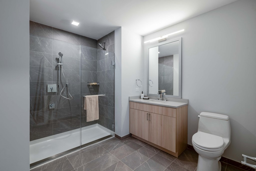 a bathroom with a toilet sink and shower