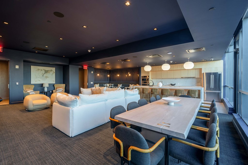 a living room and dining room with couches and a table