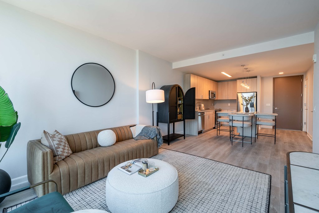 a living room with a couch and a table and a kitchen