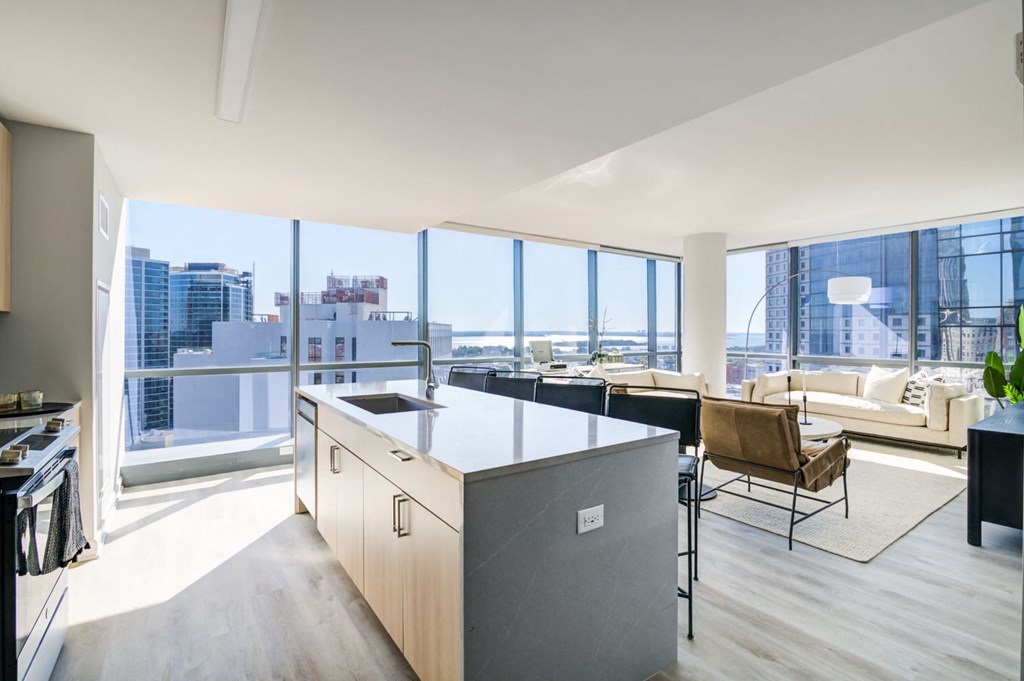 a kitchen and living room with a view of the city
