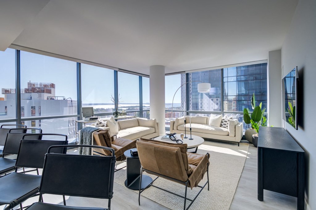 a living room filled with furniture and a large window