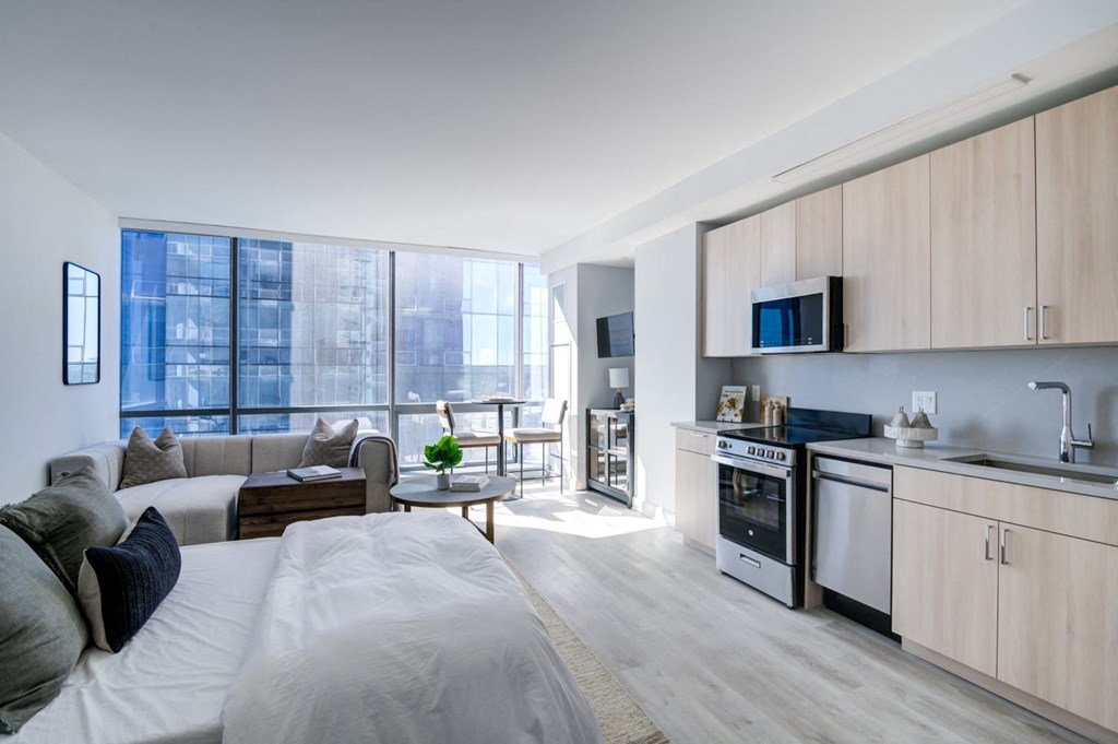a living room with a couch and a kitchen in a apartment