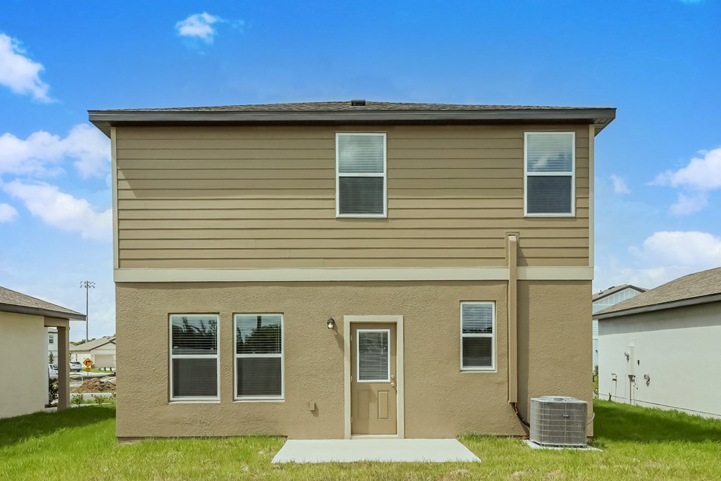A beige house with a brown door and windows.