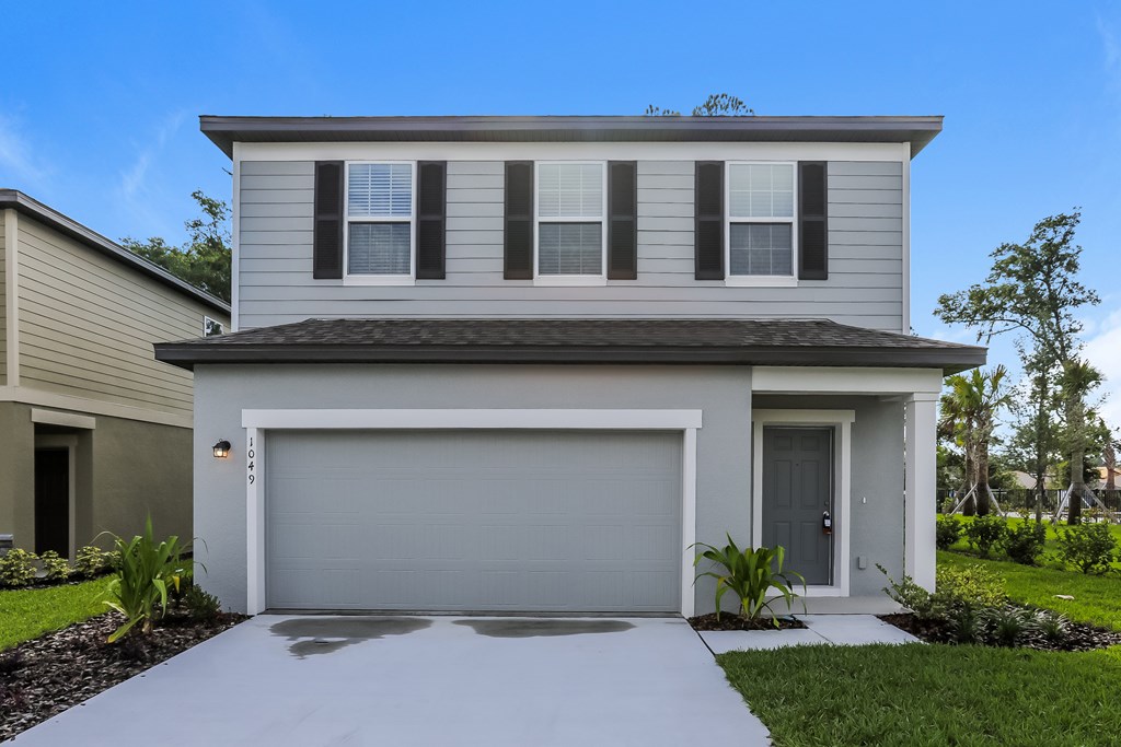 A modern house with a grey garage door.