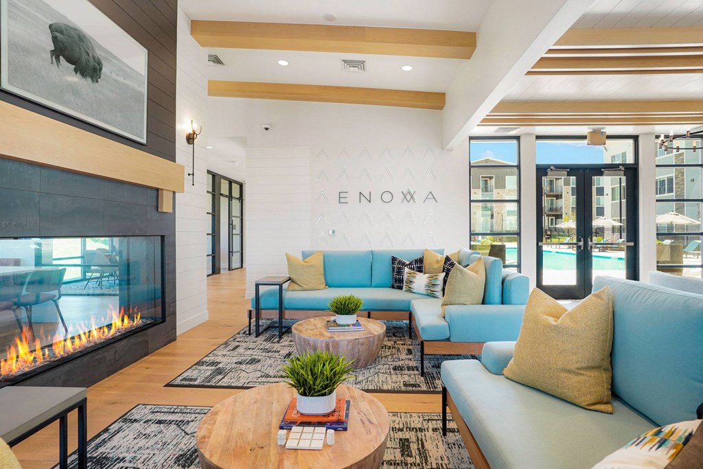 a living room with blue couches and a fireplace