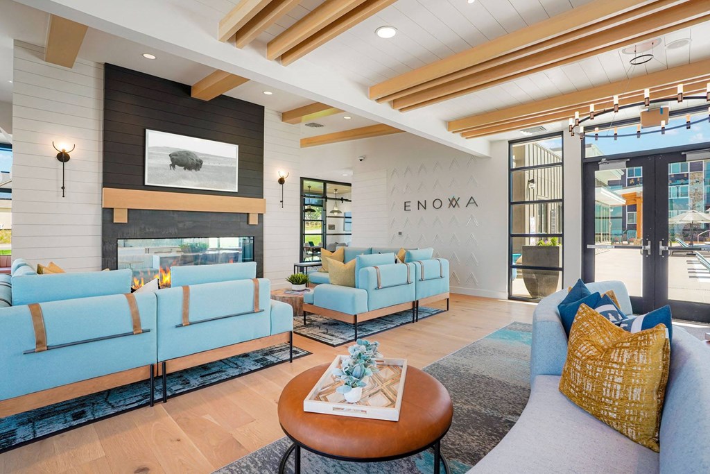 a living room with blue couches and a fireplace