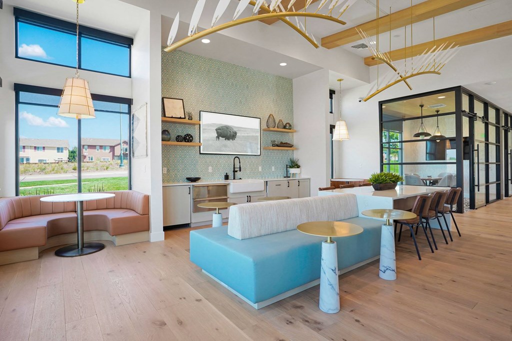 a living room with a blue couch and tables