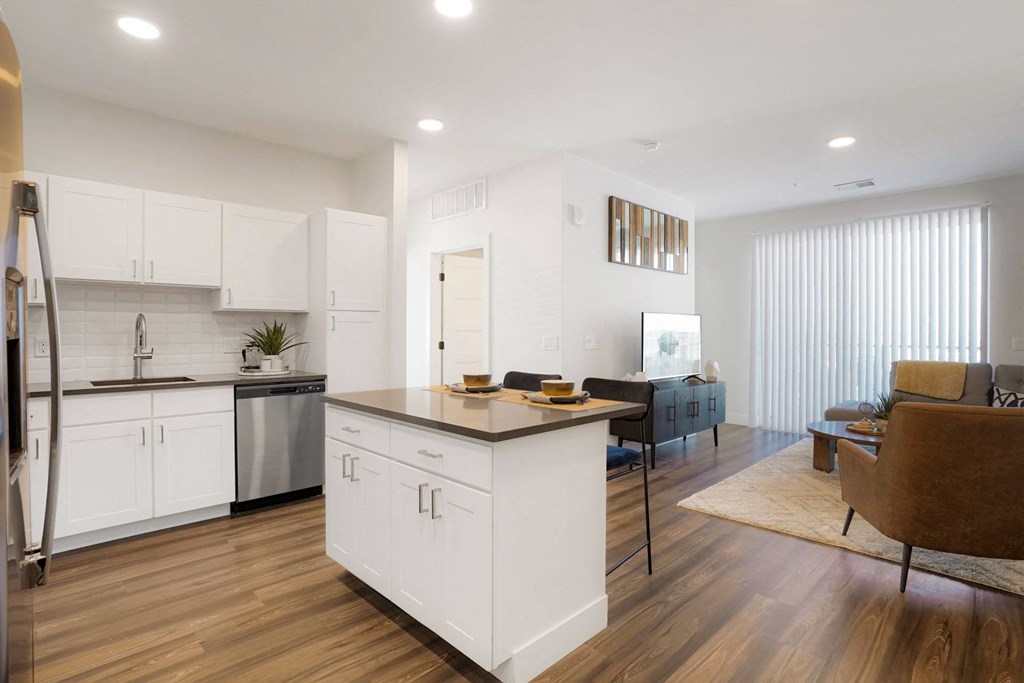 an open living room with a kitchen and a dining room