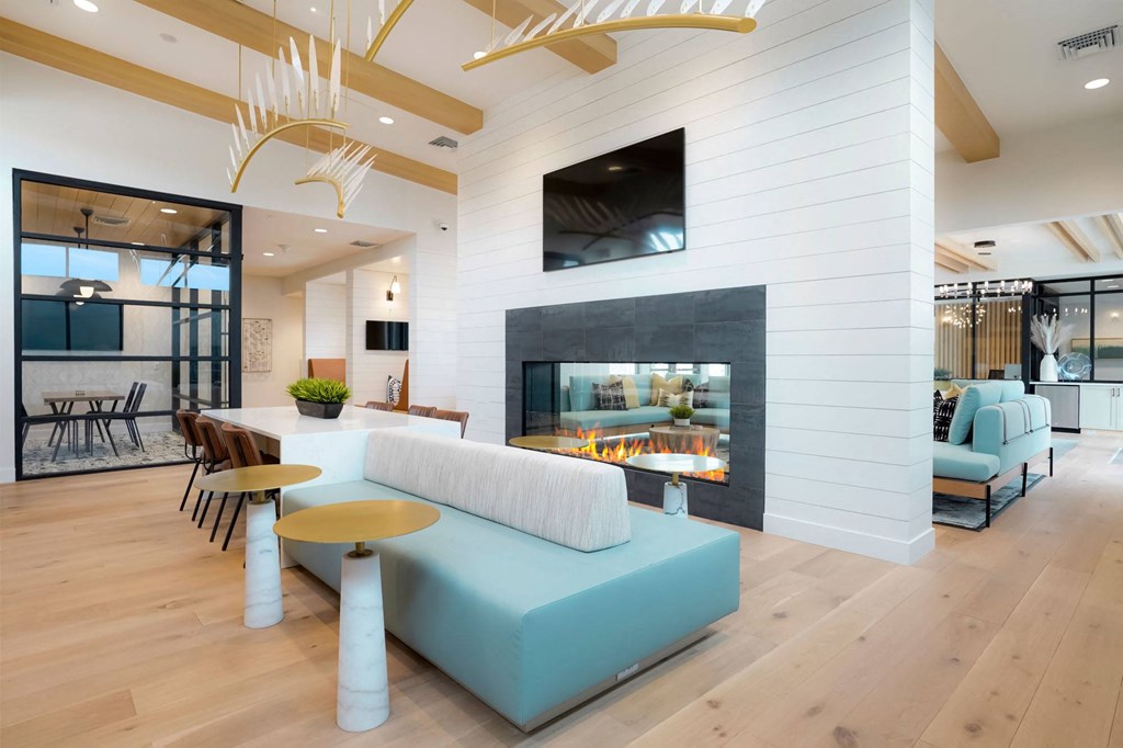 a living room with a blue couch and a fireplace