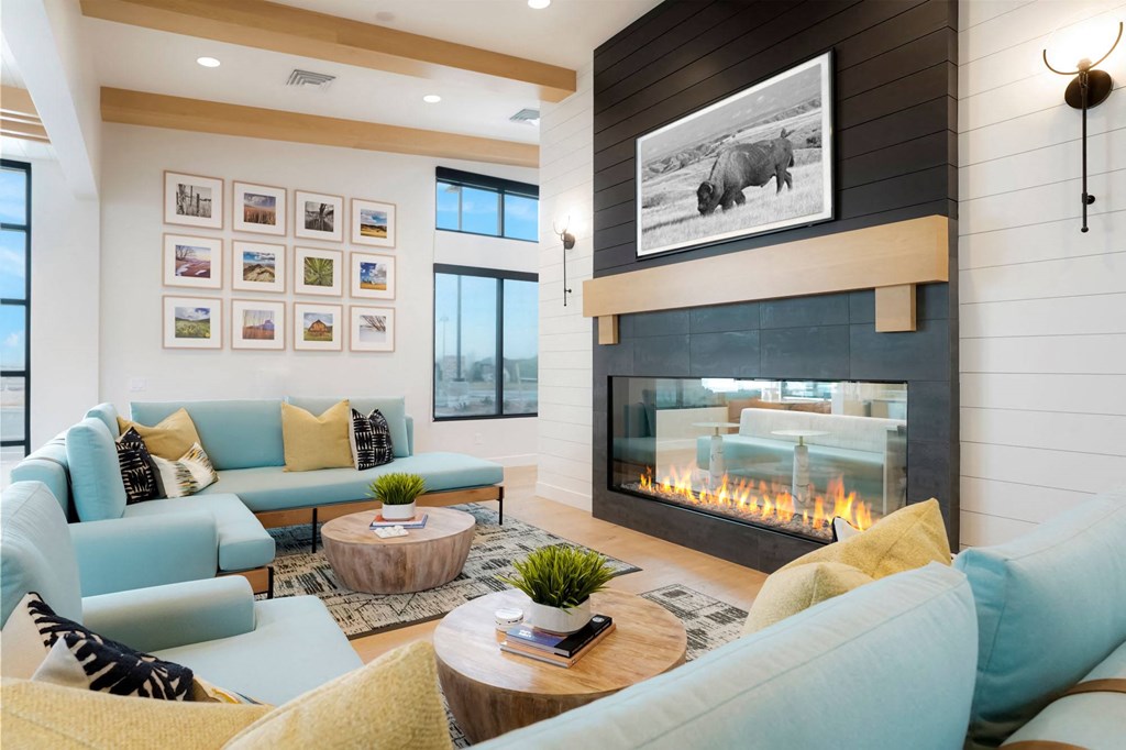 a living room with blue couches and a fireplace