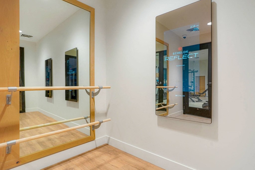 a room with a mirror and a glass door