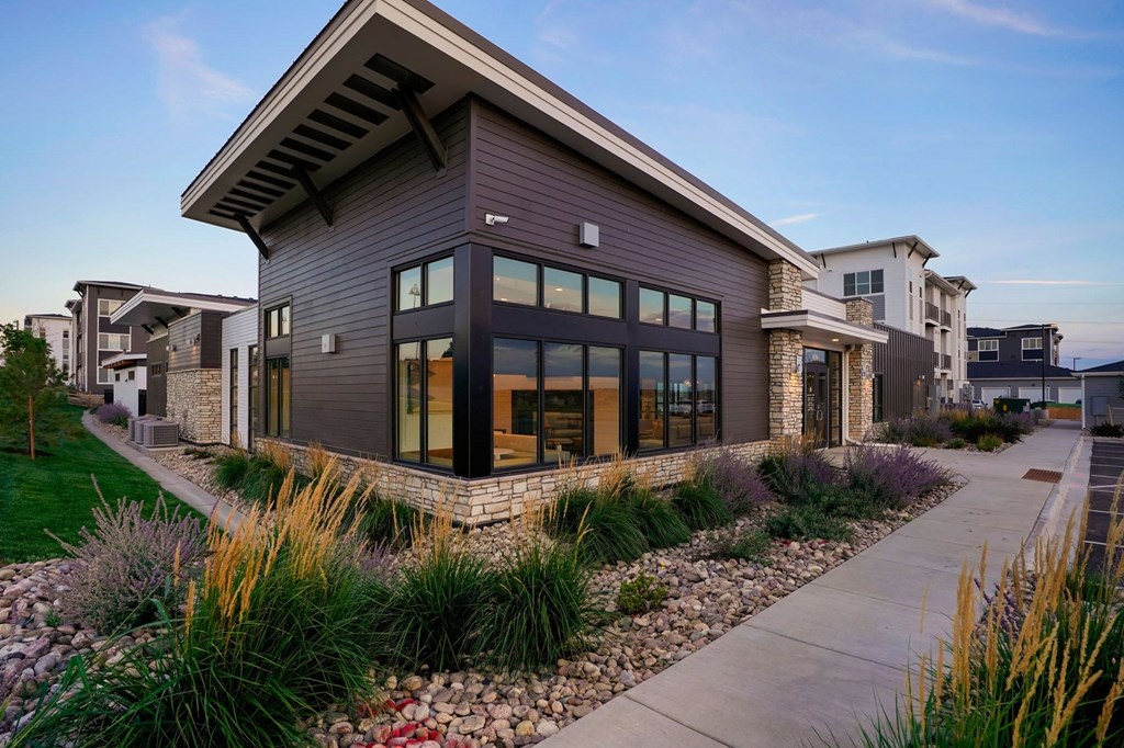 a modern house with a sidewalk in front of it