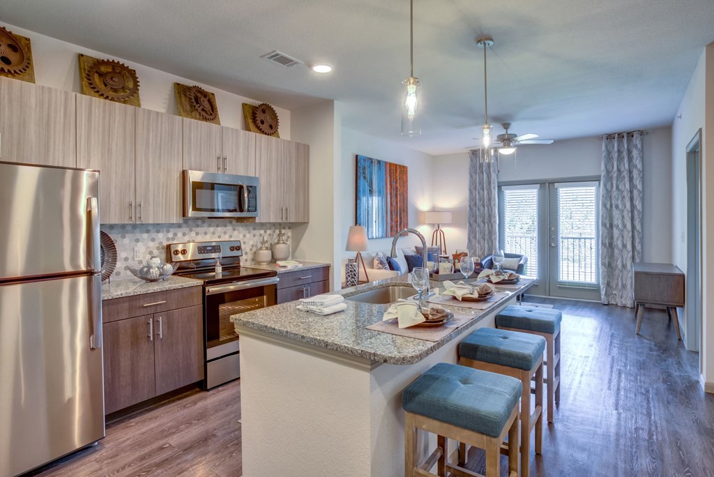 Georgetown Apartments for Rent - Williamson at The Overlook - Kitchen with Stainless-Steel Appliances, Kitchen Island, and Granite-Style Countertops