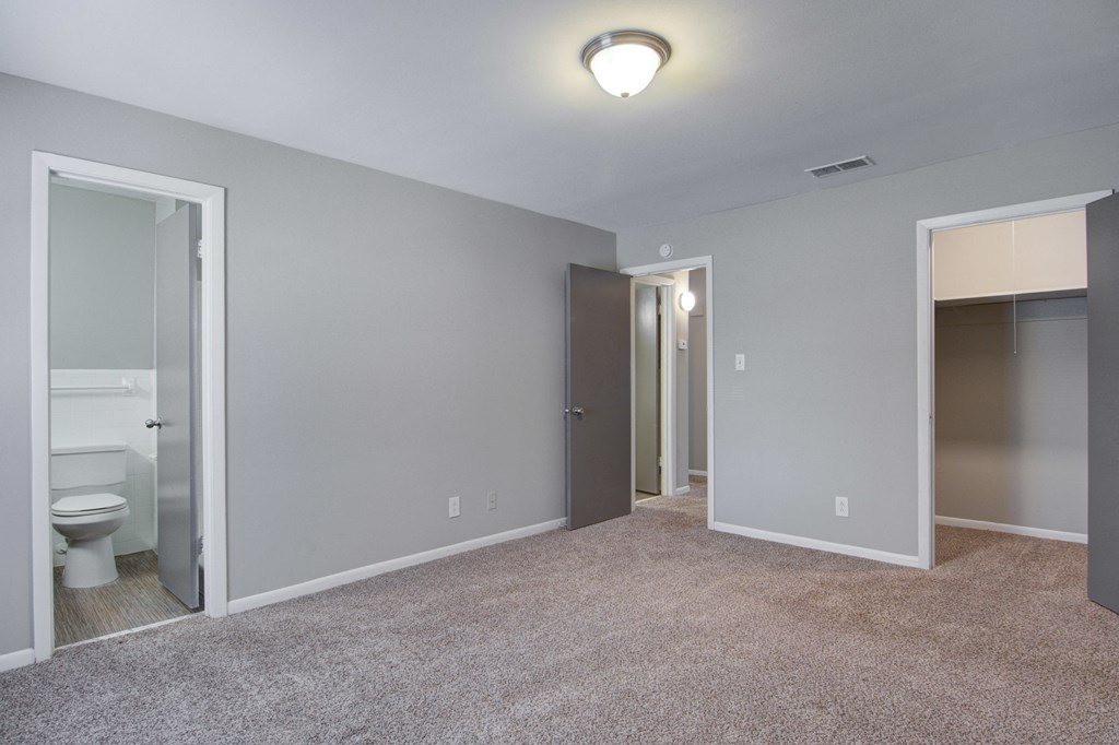 Spacious bedroom with large windows and ample natural light at pet-friendly Estuary apartments in Atlanta, GA 30341, near Chamblee and Brookhaven.