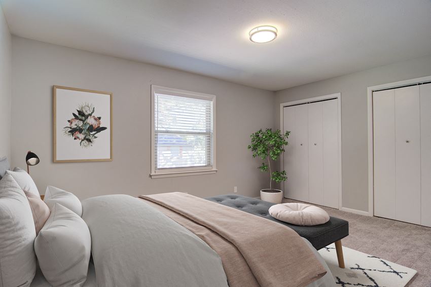Estuary Apartments in Atlanta Georgia 30341 photo of a bedroom with a large bed and two closets - Photo Gallery
