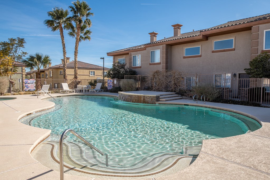 a swimming pool with a building in the background