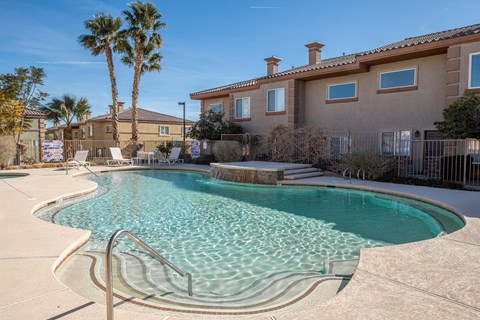 a swimming pool with a building in the background
