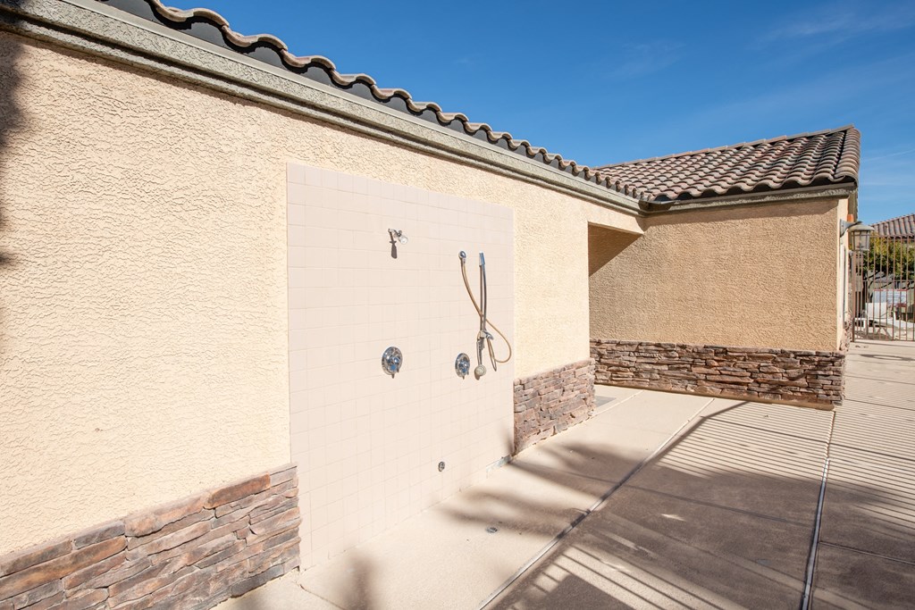 a garage with a white wall and a door with a hose on it