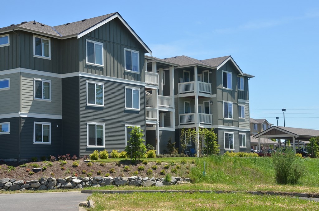 an apartment building on the side of a road