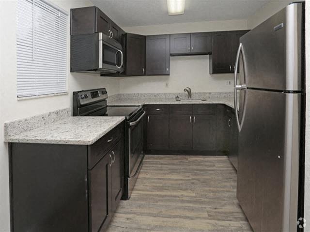 39th Avenue apartments in Gainesville, FL photo of kitchen with wood-style flooring