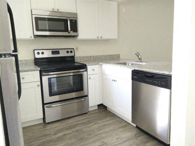 39th Avenue apartments in Gainesville, FL photo of updated kitchen with stainless steel appliances