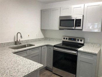 updated kitchen with stainless steel appliances and granite counter tops