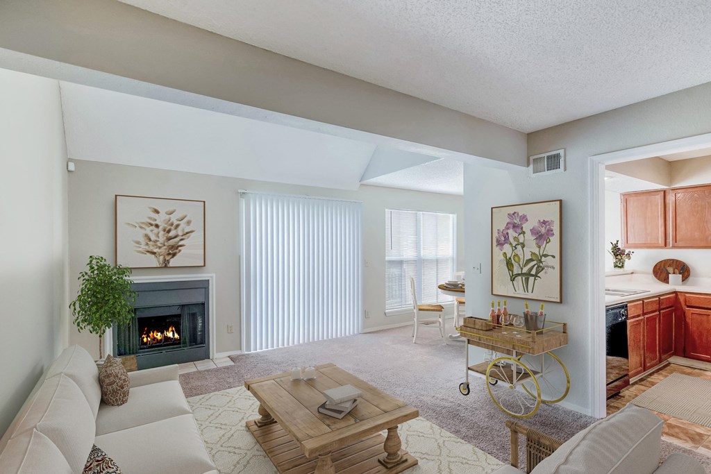a living room with a couch and a table in front of a fireplace