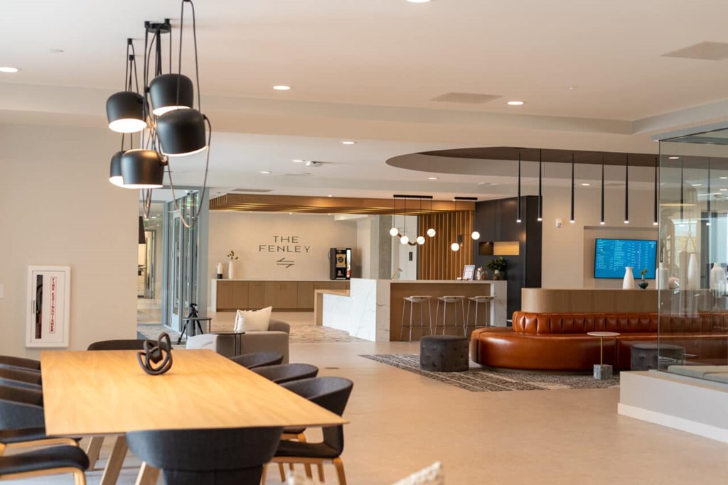 A modern lobby with a wooden table and chairs.