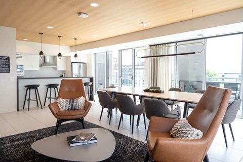 A modern living room with a brown leather chair and a grey coffee table.