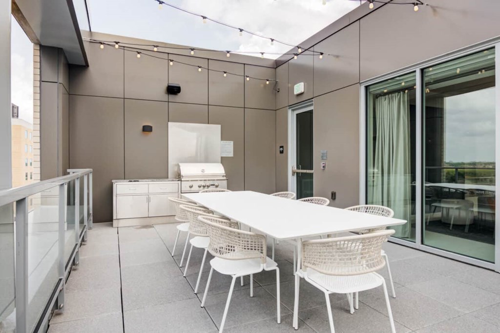 A white table and chairs are set up on a patio.