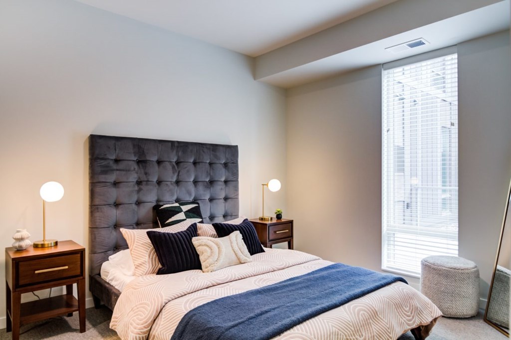 A bedroom with a large bed and a blue headboard.