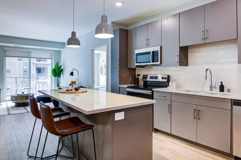 A kitchen with a table and chairs.