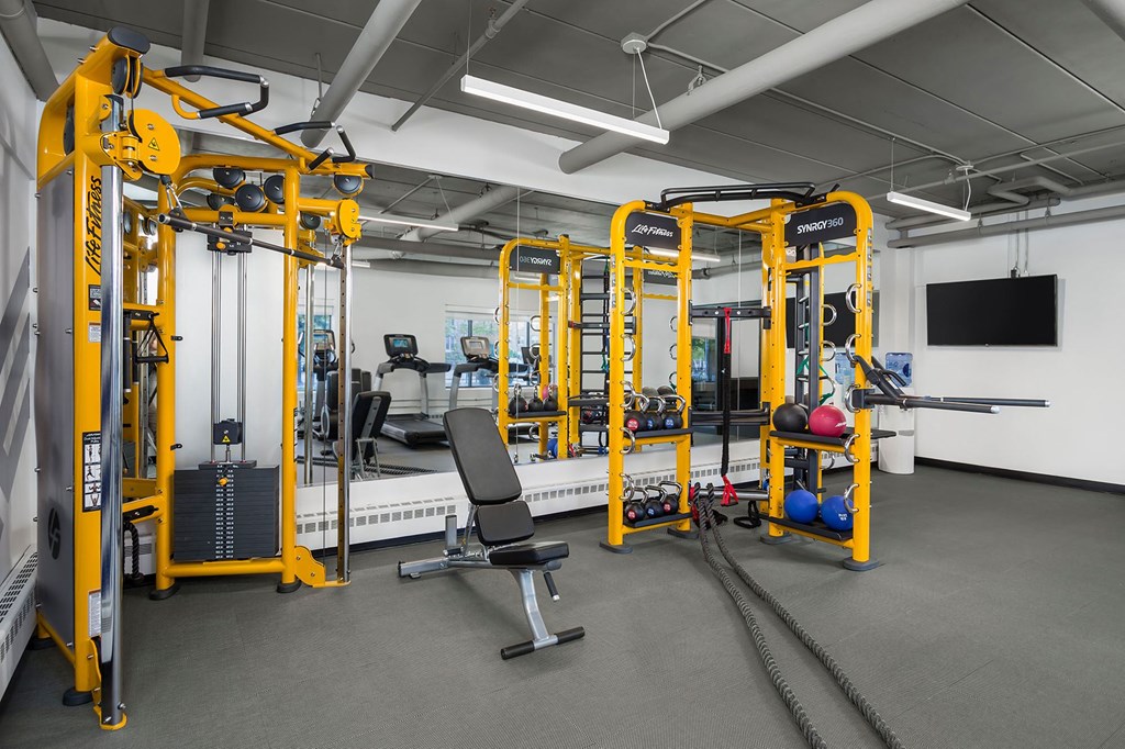 a workout room with weights and other equipment in a gym