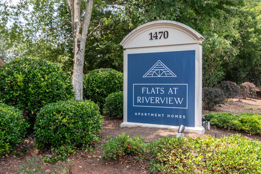 Community entrance sign at Flats at River View apartments in Duluth, GA, near Lawrenceville.