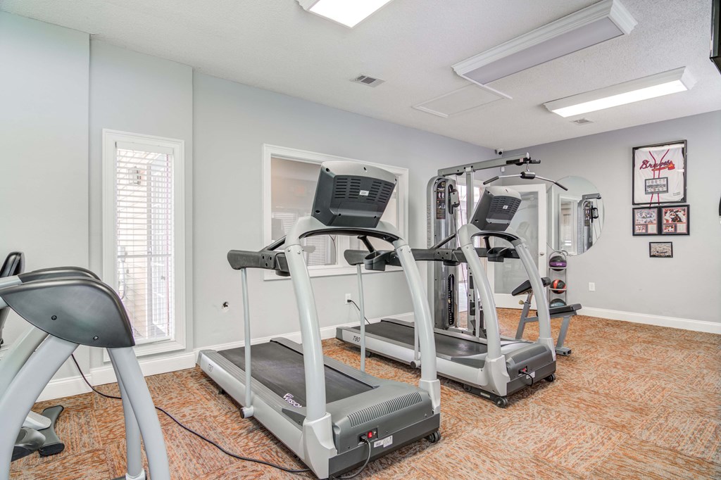 Equipped fitness center with cardio and strength machines at Flats at River View apartments in Duluth, GA, near Lawrenceville.