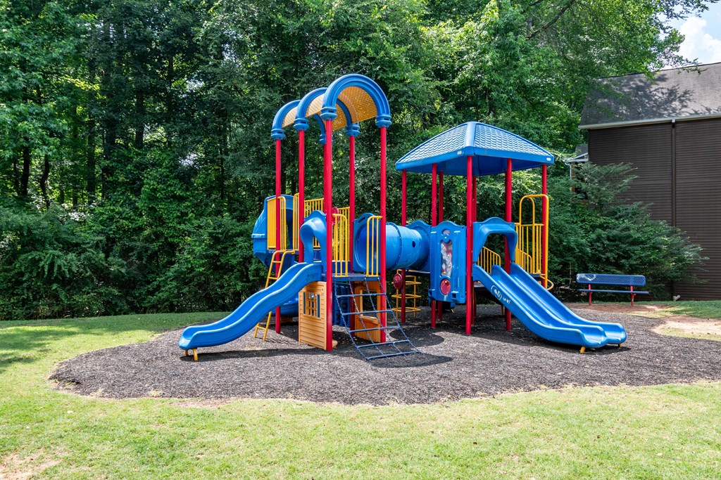 Community playground with safe play structures at Flats at River View apartments in Duluth, GA, near Lawrenceville.