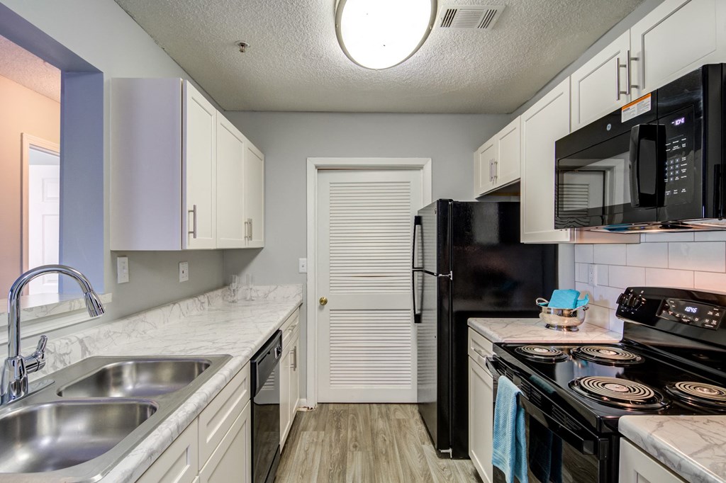 Kitchen with black appliances at Forest Glen apartments in Austell, GA 30106, near South Cobb County and Douglasville.