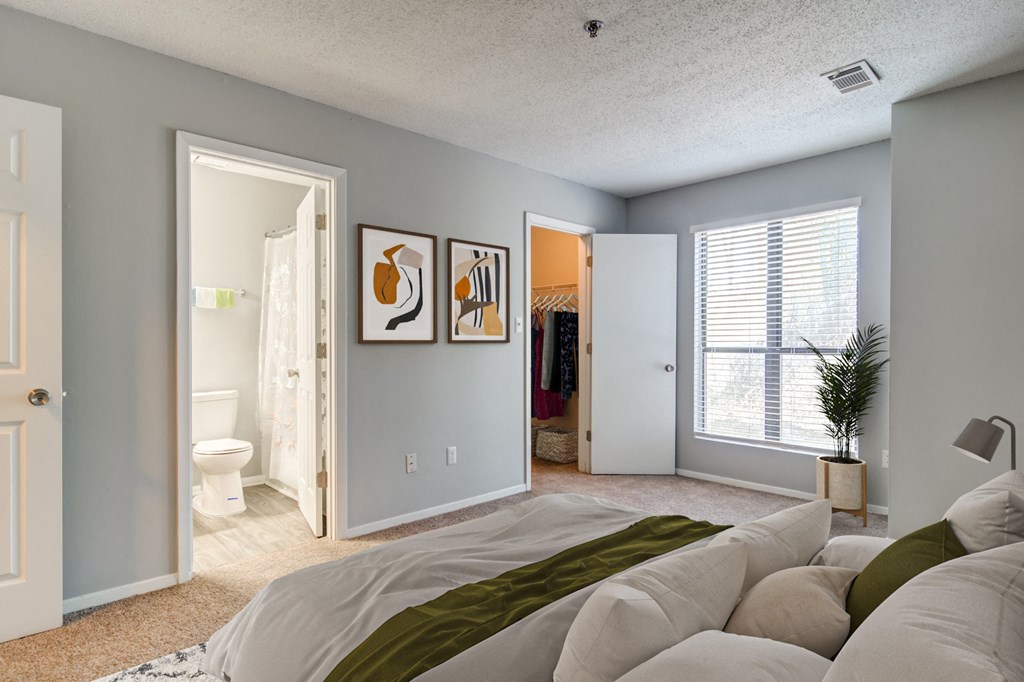 Well-lit bedroom with ample space at Forest Glen apartments in Austell, GA 30106, near South Cobb County and Douglasville.