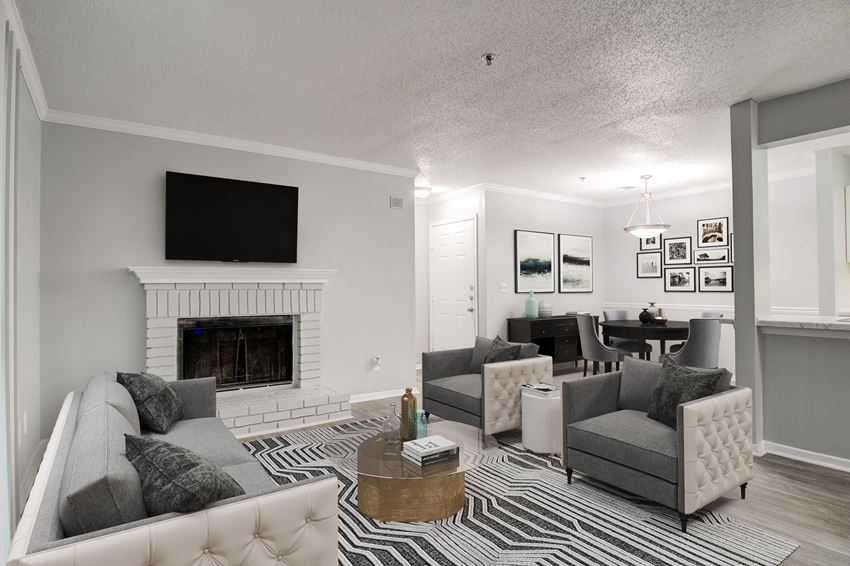 Forest Glen apartments in Austell, GA photo of a living room with a fireplace and a tv above it