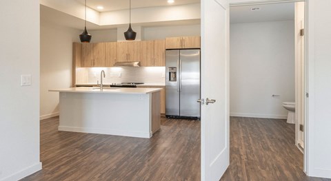 A kitchen with a white counter and wooden cabinets.